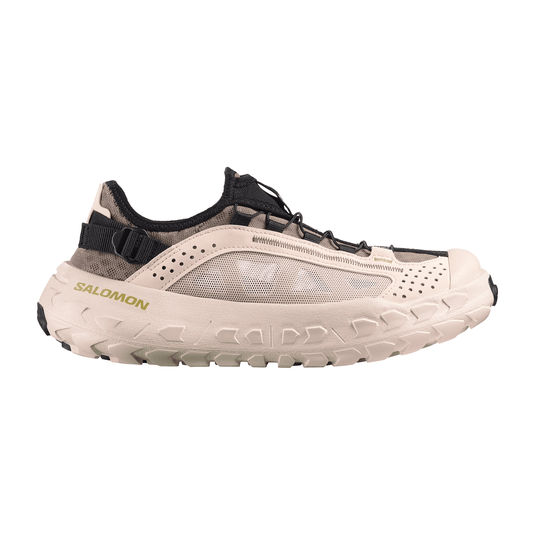 Beige and black Salomon shoe on a white background