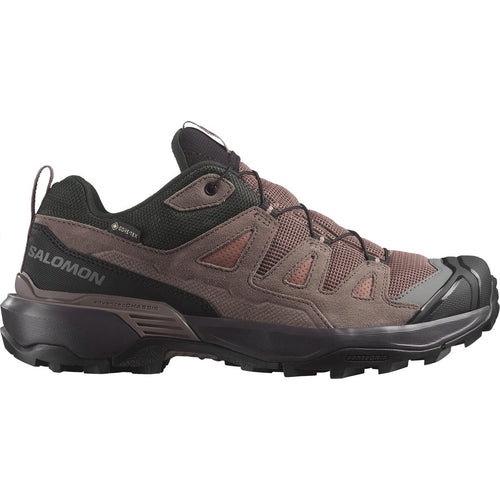 Brown hiking shoe with black sole on a white background