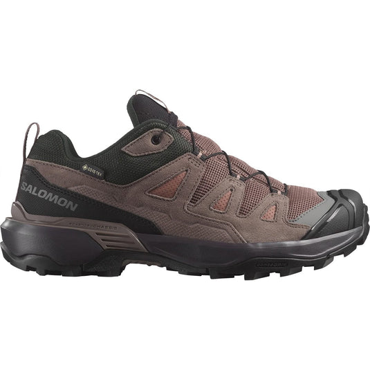 Brown hiking shoe with black sole on a white background