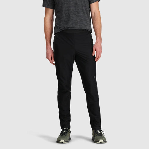Person wearing black pants and a dark shirt on a light gray background