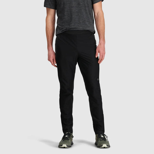 Person wearing black pants and a dark shirt on a light gray background