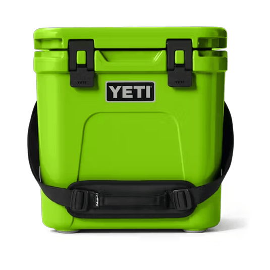 Green YETI cooler with black straps on a white background