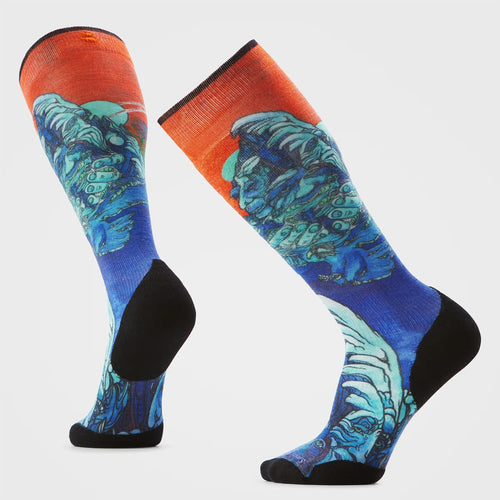 Colorful socks with a blue and green design on an orange background