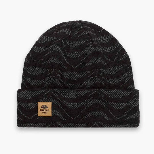 Black beanie with zigzag pattern and Turtle Fur label on a white background
