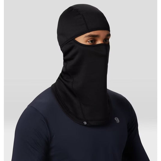 Person wearing a black full-face covering against a light gray background