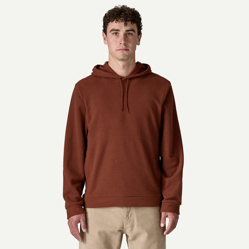 Man wearing a brown hoodie on a white background