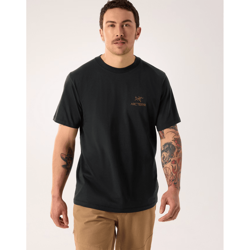 Load image into Gallery viewer, Man wearing a black t-shirt with a logo on a white background
