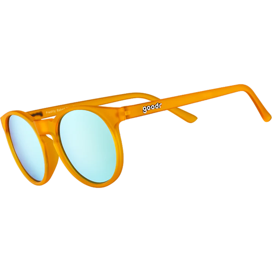 Orange sunglasses with blue lenses on a white background