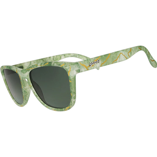 Green sunglasses with a patterned frame on a white background