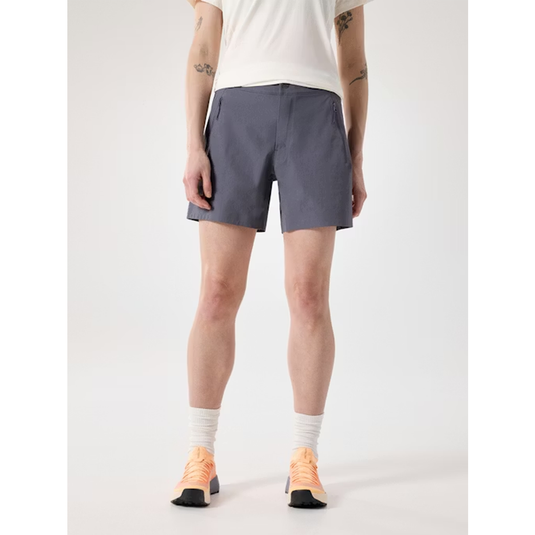 Person wearing gray shorts on a white background