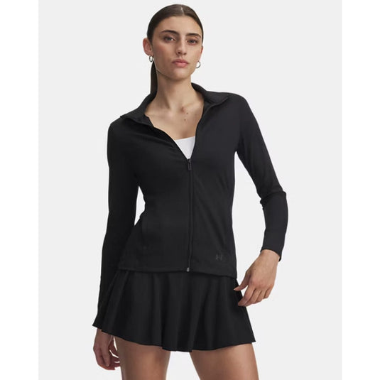 Woman wearing a black athletic jacket and skirt on a white background