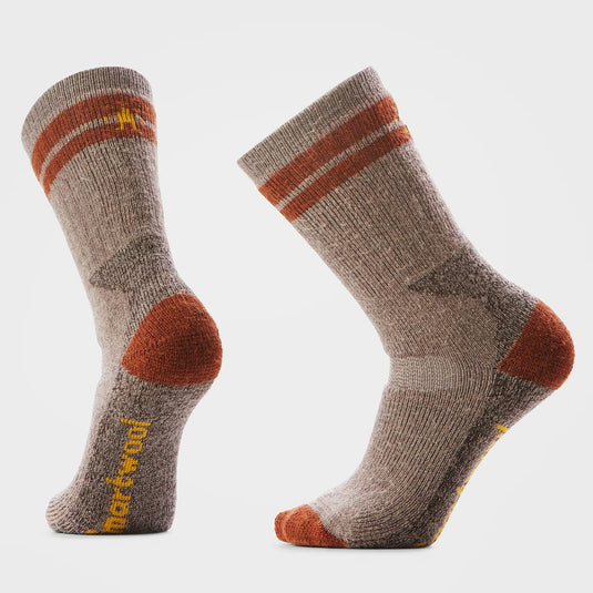 Pair of brown socks with orange accents on a light gray background