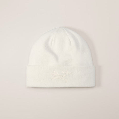 White beanie hat on a light pink background