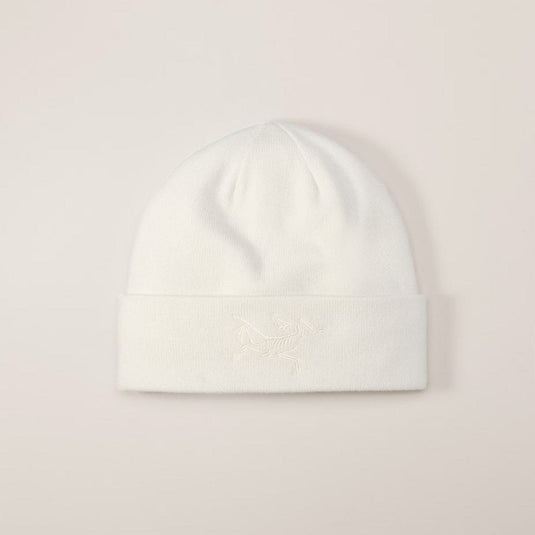 White beanie hat on a light pink background