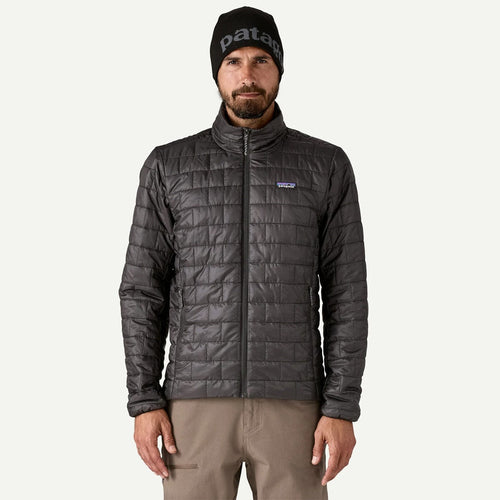 Man wearing a Patagonia jacket and beanie on a white background
