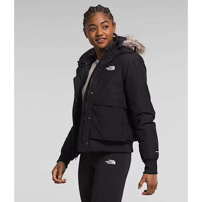 Load image into Gallery viewer, Person wearing a black jacket with a fur-lined hood on a gray background
