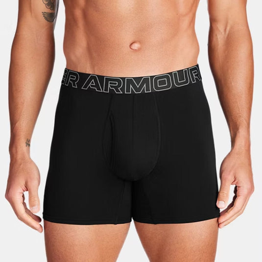 Black Under Armour boxer briefs worn by a person on a plain background