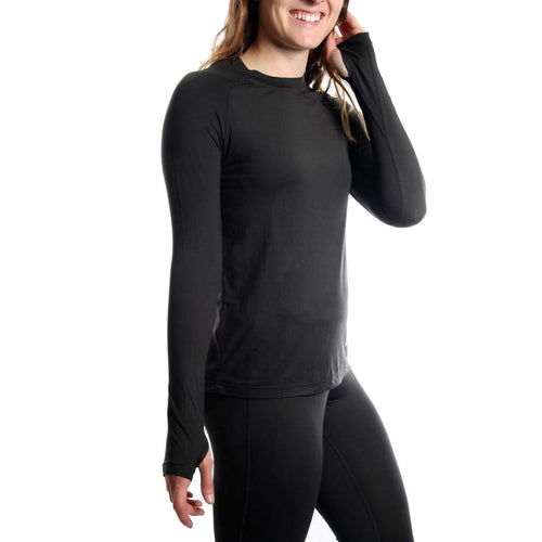 Person wearing a black long-sleeve athletic shirt and leggings on a white background