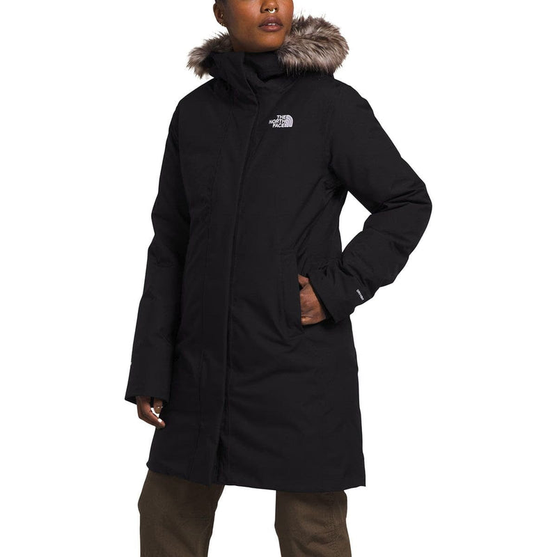Load image into Gallery viewer, Person wearing a black coat with fur hood on a white background
