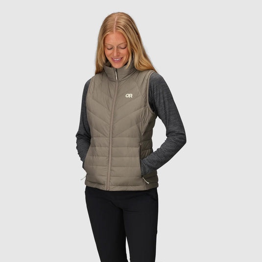Woman wearing a gray puffer vest with a logo on a white background