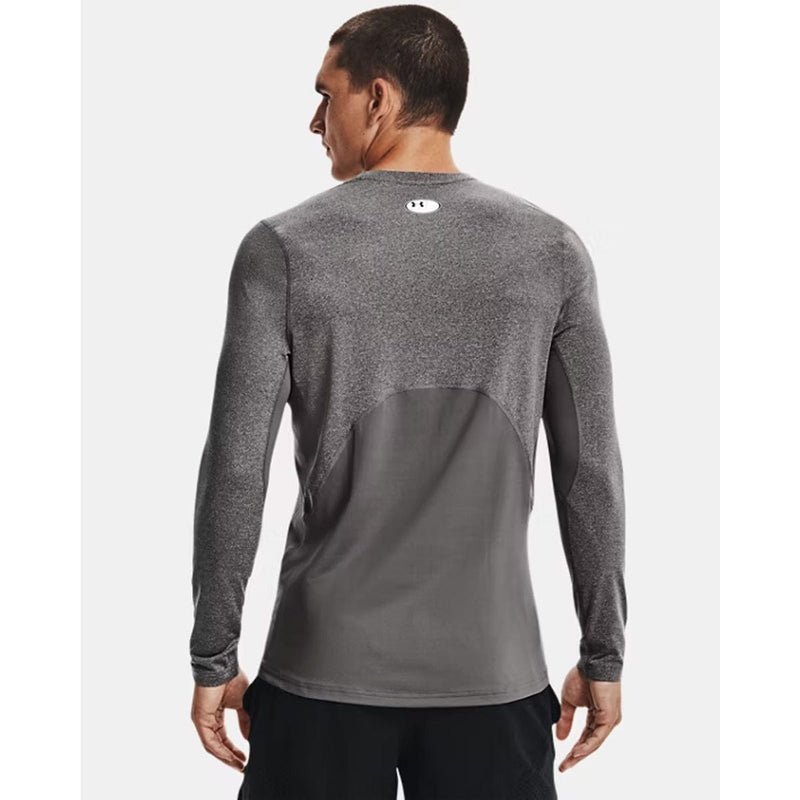 Load image into Gallery viewer, Person wearing a gray long-sleeve athletic shirt with a brand logo on the back.
