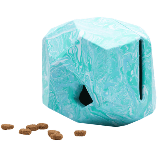 Marble-patterned dog puzzle toy with treats on a white background