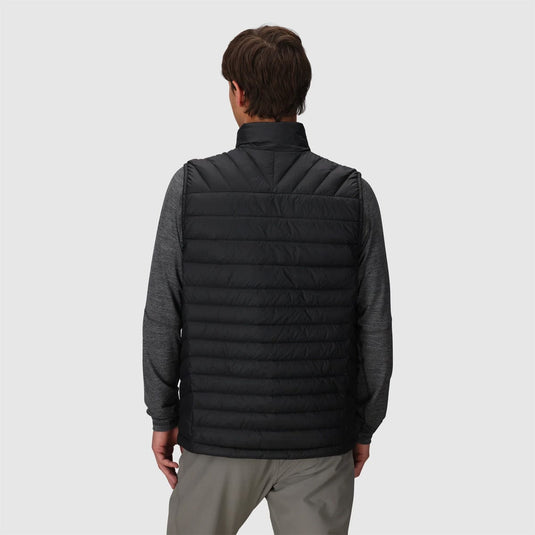 Person wearing a black puffer vest on a light gray background