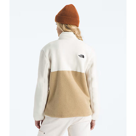 Person wearing a two-tone fleece jacket with The North Face logo on a white background