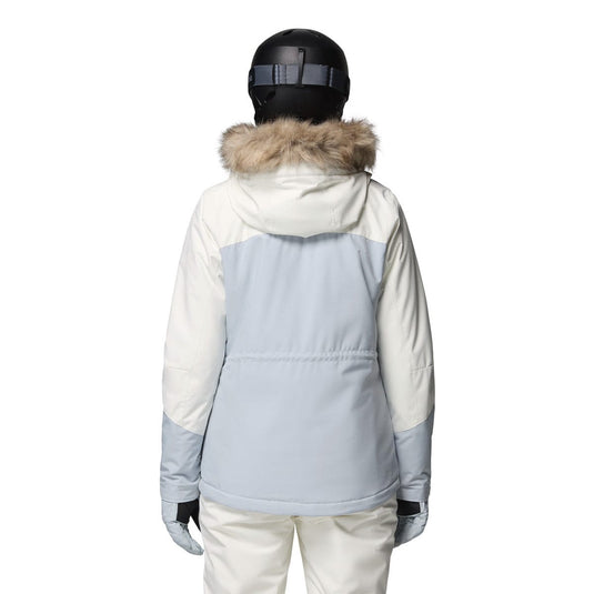 Person wearing a two-tone snow jacket with fur-lined hood on a white background