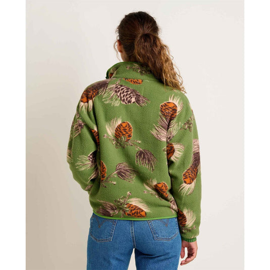 Person wearing a green jacket with nature-themed pattern on a plain background