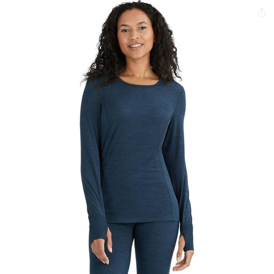 Woman wearing a blue long-sleeve top and pants on a white background