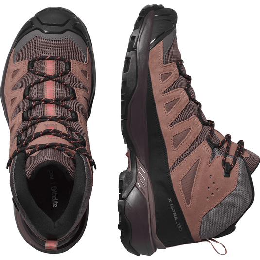 Pair of brown hiking boots with black accents on a white background