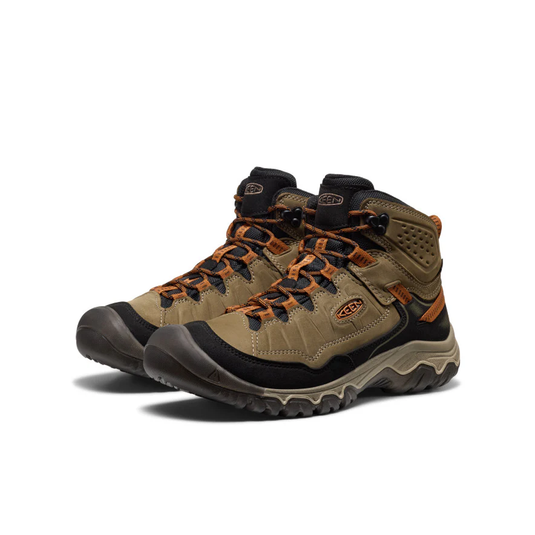 Pair of brown hiking boots with orange accents on a white background