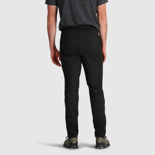 Person wearing black pants on a light gray background