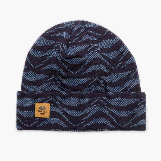 Navy blue beanie with blue zigzag pattern and brand label on a white background