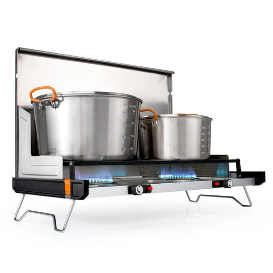 Portable gas stove with stainless steel pots on a white background
