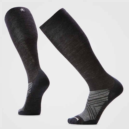 Pair of black knee-high socks on a light gray background