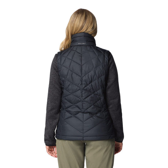 Person wearing a black quilted jacket on a white background