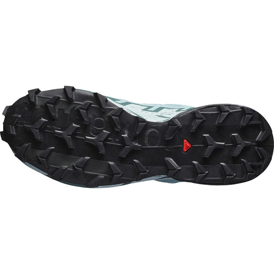 Close-up of a shoe sole with a detailed tread pattern on a white background