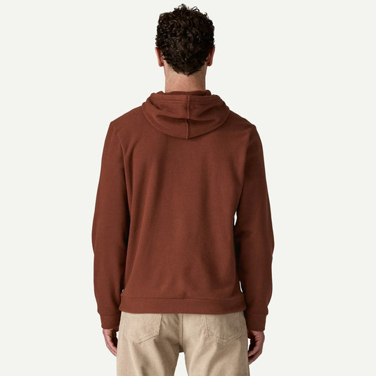 Person wearing a brown hoodie on a white background