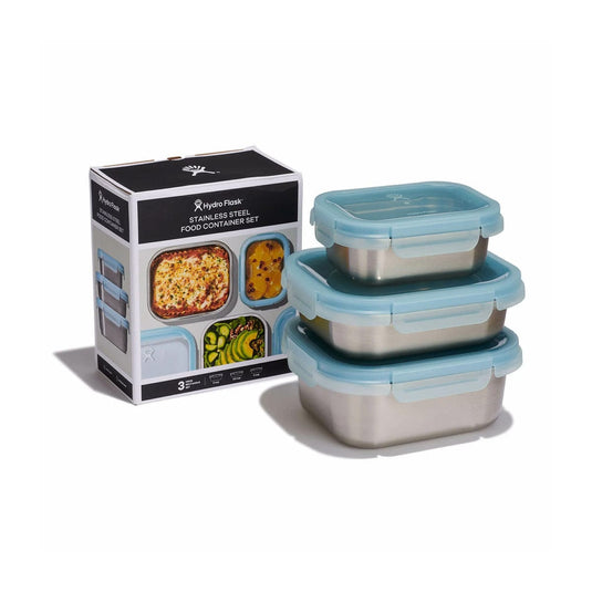 Set of stainless steel food containers with blue lids and packaging on a white background