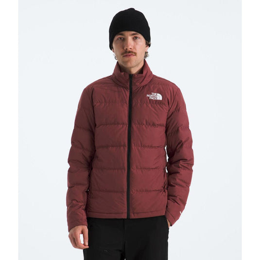 Person wearing a maroon puffer jacket with a brand logo on a white background