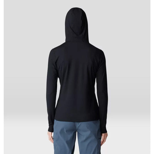 Person wearing a black hoodie and gray pants on a light gray background