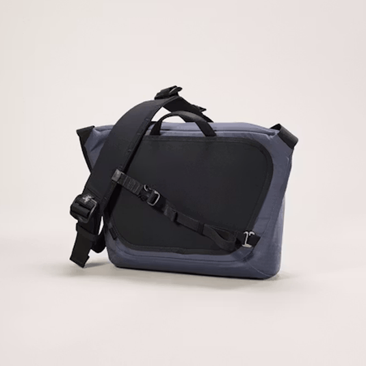 Blue and black bag with a strap on a light gray background