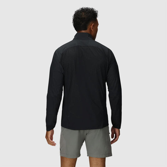 Person wearing a black long-sleeve shirt and gray shorts on a light gray background