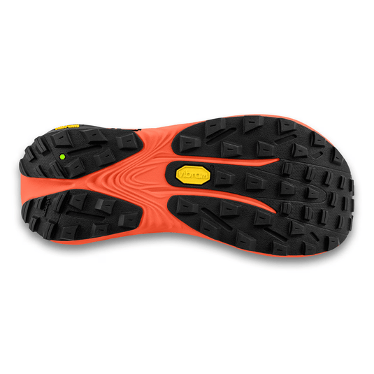 Close-up of a shoe sole with orange and black tread pattern on a white background