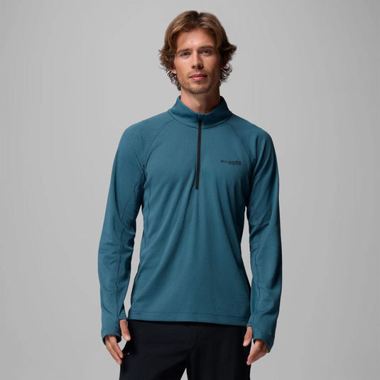 Man wearing a teal long-sleeve pullover with a zipper on a gray background