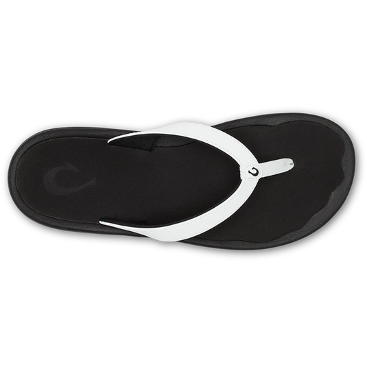Black sandal with white strap on a white background