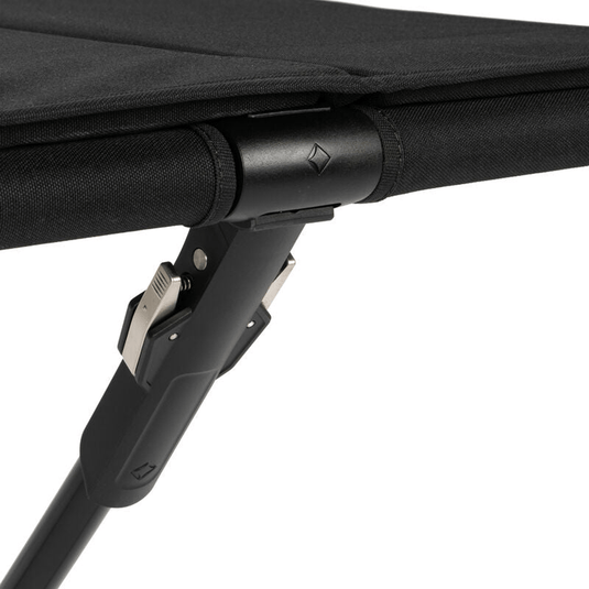 Close-up of a black folding chair with a white background