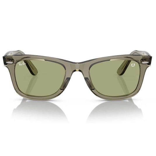 Sunglasses with a transparent frame and green lenses on a white background